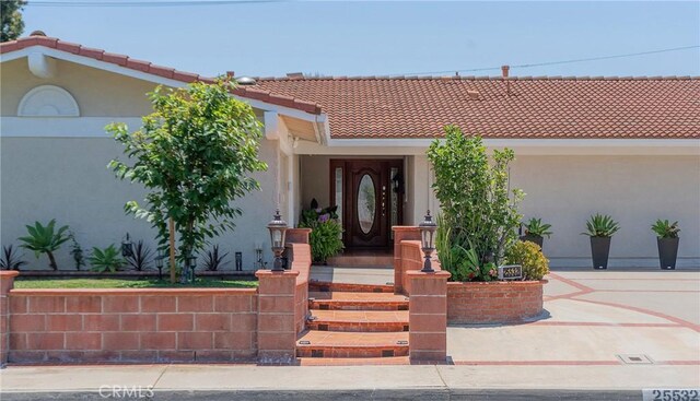 25532 Maximus St, Mission Viejo, CA 92675 - doorway to property with stucco siding and a tile roof