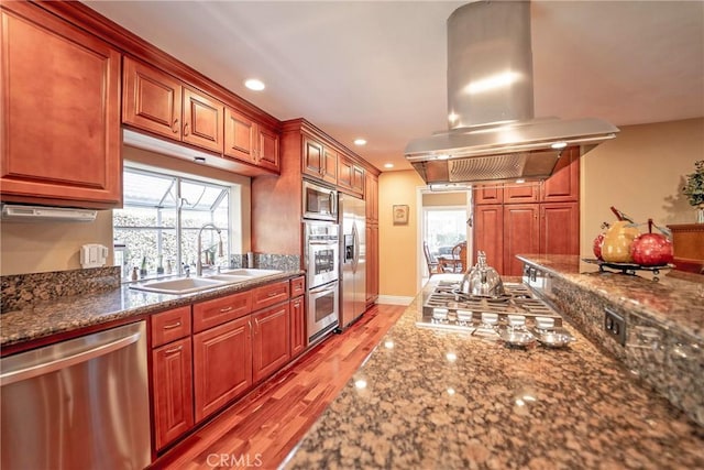 25532 Maximus St, Mission Viejo, CA 92675 - kitchen featuring appliances with stainless steel finishes, island range hood, plenty of natural light, light wood finished floors, and recessed lighting