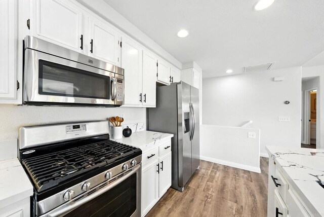 1250 Pinnacle Peak, Chula Vista, CA 91915 - kitchen featuring stainless steel appliances, white cabinets, light wood finished floors, recessed lighting, and light stone counters