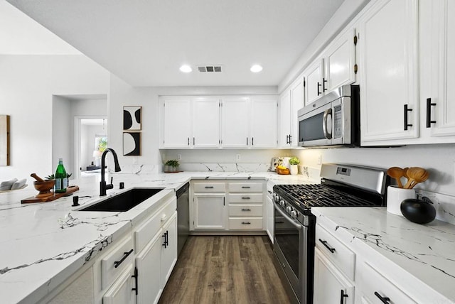 1250 Pinnacle Peak, Chula Vista, CA 91915 - kitchen with appliances with stainless steel finishes, light stone counters, white cabinets, dark wood finished floors, and recessed lighting