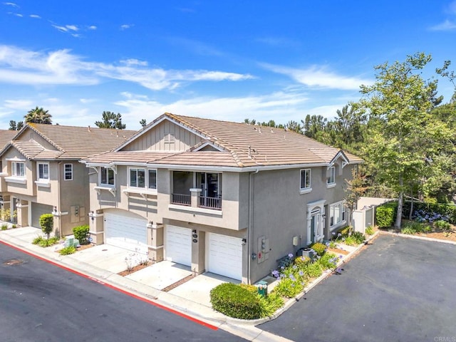 1250 Pinnacle Peak, Chula Vista, CA 91915 - view of property featuring a garage, a tiled roof, stucco siding, and driveway