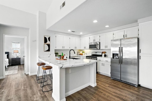 1250 Pinnacle Peak, Chula Vista, CA 91915 - kitchen featuring appliances with stainless steel finishes, dark wood-type flooring, white cabinets, light stone counters, and recessed lighting