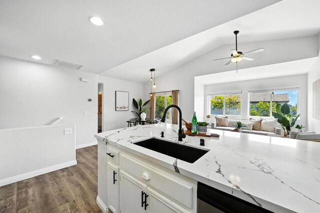 1250 Pinnacle Peak, Chula Vista, CA 91915 - kitchen with light stone countertops, open floor plan, a ceiling fan, white cabinets, and vaulted ceiling
