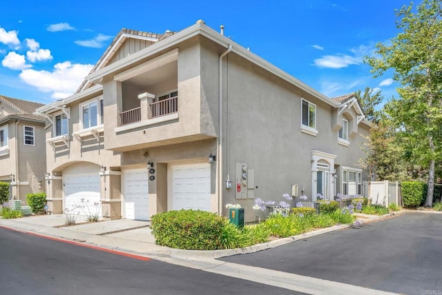 1250 Pinnacle Peak, Chula Vista, CA 91915 - townhome / multi-family property with stucco siding, an attached garage, driveway, and a balcony