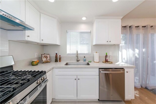 918 Huntington Dr Unit O, Duarte, CA 91010 - kitchen featuring stainless steel appliances, range hood, light countertops, white cabinets, and recessed lighting