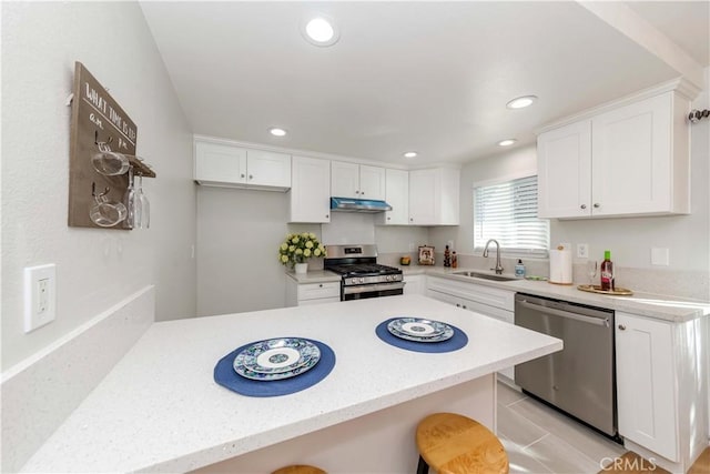 918 Huntington Dr Unit O, Duarte, CA 91010 - kitchen featuring stainless steel appliances, under cabinet range hood, a peninsula, white cabinetry, and recessed lighting