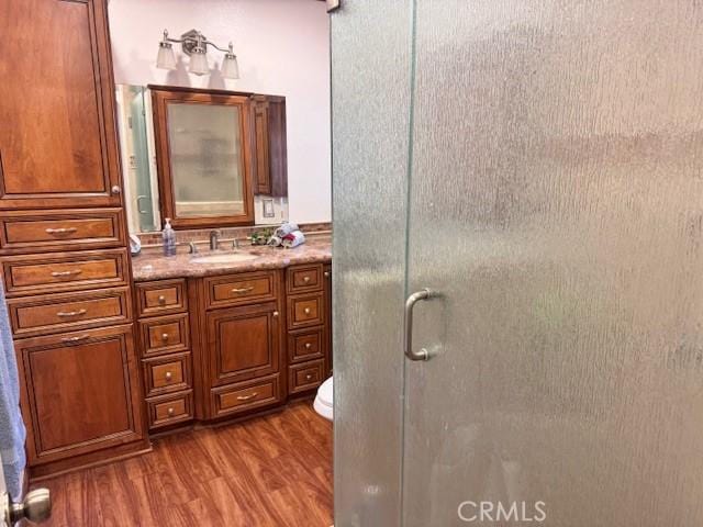 15945 Lashburn St, Whittier, CA 90603 - bathroom featuring wood finished floors, vanity, and a shower stall