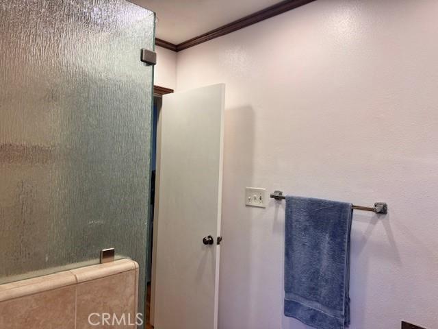 15945 Lashburn St, Whittier, CA 90603 - bathroom with ornamental molding and a shower