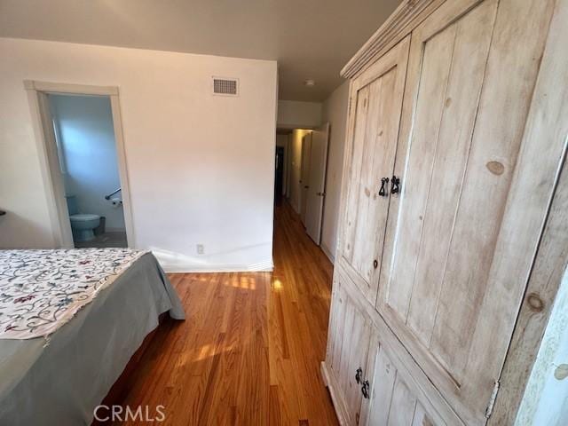 15945 Lashburn St, Whittier, CA 90603 - bedroom with wood finished floors, ensuite bath, and a closet
