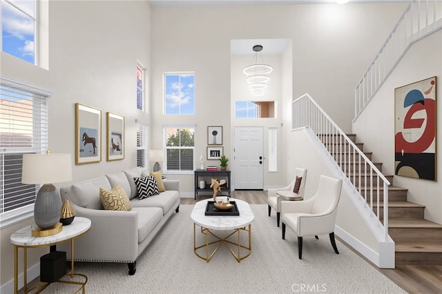 31772 Ridgeview Dr, Lake Elsinore, CA 92532 - living room with a high ceiling, stairs, wood finished floors, and plenty of natural light