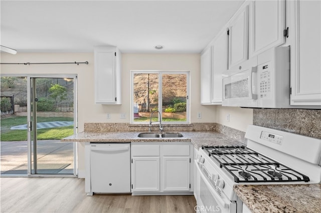 31772 Ridgeview Dr, Lake Elsinore, CA 92532 - kitchen featuring white appliances, plenty of natural light, white cabinetry, and light wood-style floors
