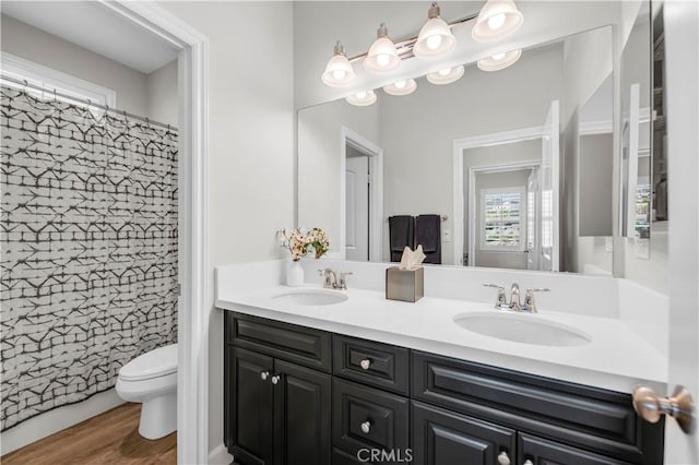 33303 Barmetta Ln, Temecula, CA 92592 - bathroom with double vanity, a shower with shower curtain, and wood finished floors