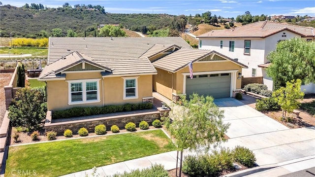 33303 Barmetta Ln, Temecula, CA 92592 - view of front facade featuring stucco siding, a tile roof, concrete driveway, and an attached garage