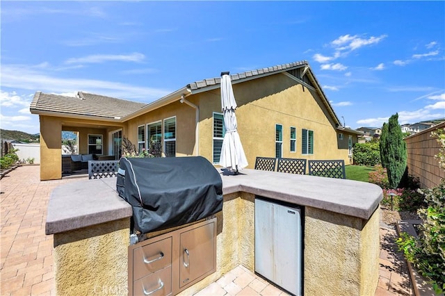33303 Barmetta Ln, Temecula, CA 92592 - view of patio / terrace featuring an outdoor living space and an outdoor kitchen