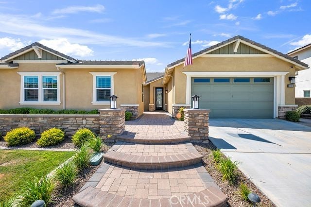 33303 Barmetta Ln, Temecula, CA 92592 - view of front facade featuring driveway, a garage, and stucco siding