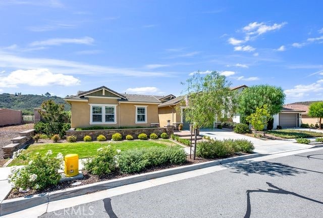 33303 Barmetta Ln, Temecula, CA 92592 - view of front of home with stucco siding, concrete driveway, an attached garage, and a front lawn