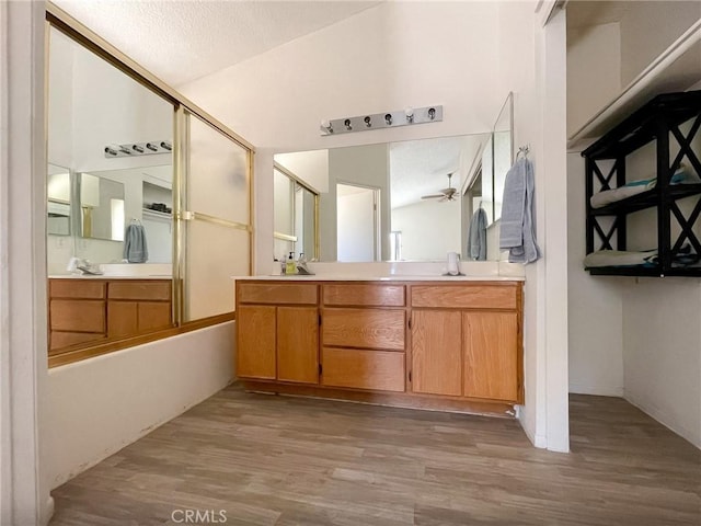 37543 Royal Ct, Palmdale, CA 93552 - bathroom featuring wood finished floors, double vanity, a ceiling fan, and lofted ceiling