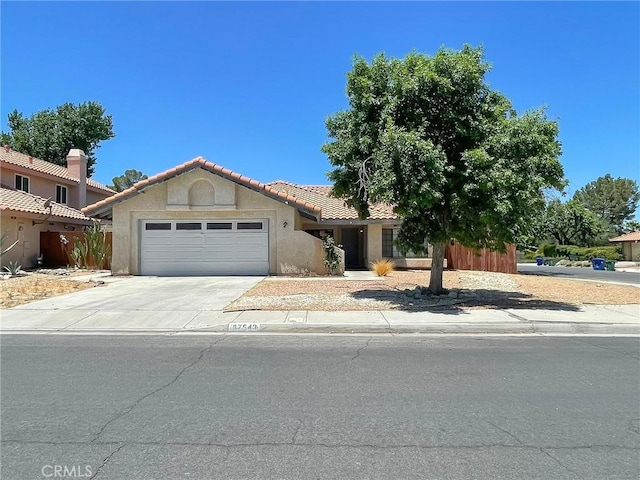 37543 Royal Ct, Palmdale, CA 93552 - view of front of house featuring a garage, stucco siding, driveway, and a tile roof