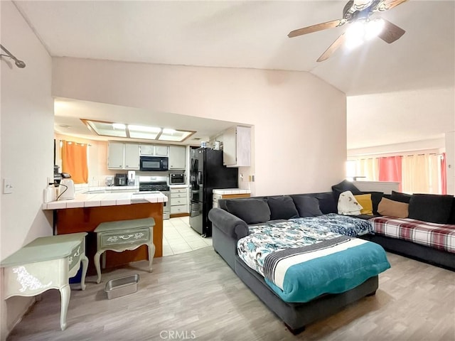 37543 Royal Ct, Palmdale, CA 93552 - living area with light wood finished floors, lofted ceiling, and ceiling fan