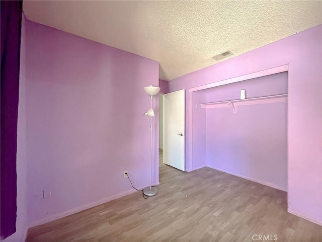 37543 Royal Ct, Palmdale, CA 93552 - unfurnished bedroom with wood finished floors, a textured ceiling, and a closet