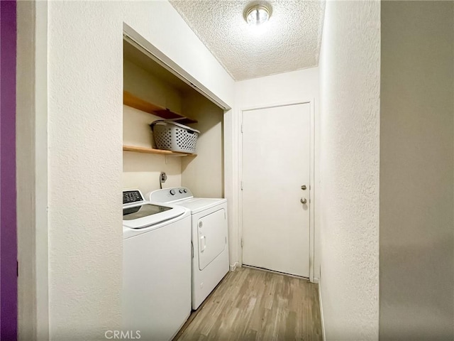 37543 Royal Ct, Palmdale, CA 93552 - washroom with washer and dryer, a textured ceiling, light wood-style flooring, and a textured wall