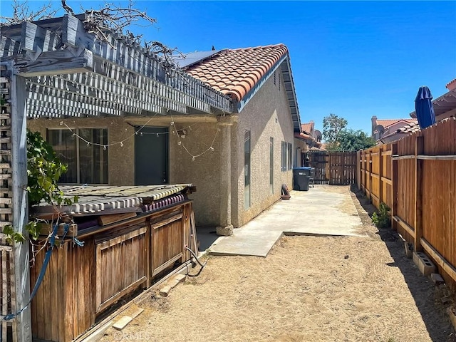 37543 Royal Ct, Palmdale, CA 93552 - back of property featuring stucco siding, a tiled roof, a fenced backyard, and a patio area