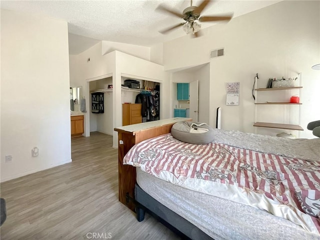 37543 Royal Ct, Palmdale, CA 93552 - bedroom featuring lofted ceiling, a closet, light wood-style flooring, a textured ceiling, and a ceiling fan