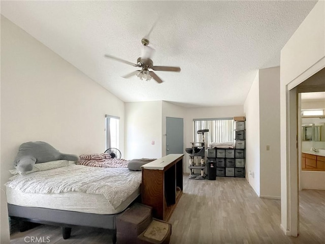 37543 Royal Ct, Palmdale, CA 93552 - bedroom with light wood-style flooring, a textured ceiling, lofted ceiling, and a ceiling fan