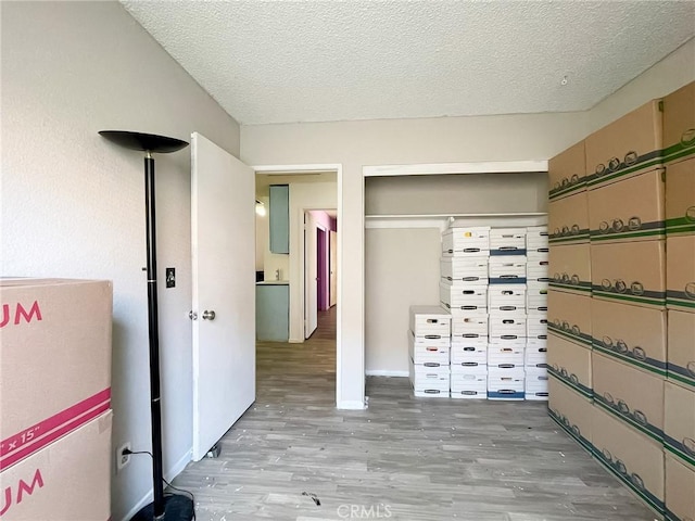 37543 Royal Ct, Palmdale, CA 93552 - unfurnished bedroom featuring light wood finished floors, a textured ceiling, and a closet