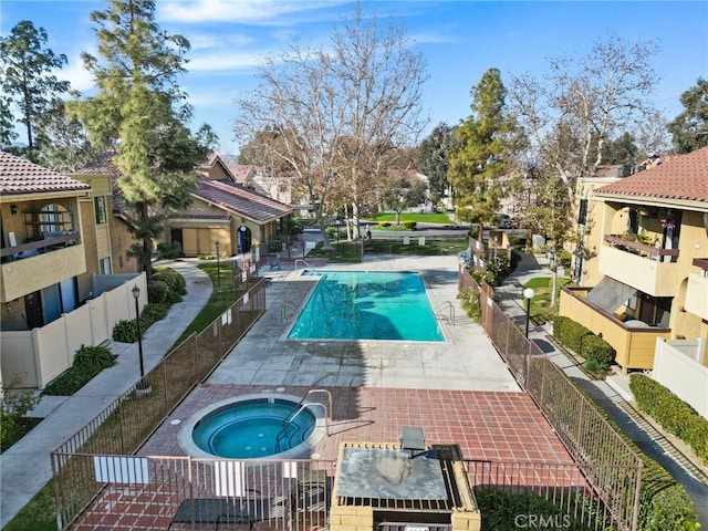 18752 Mandan St Unit 1016, Canyon Country, CA 91351 - community pool featuring a community hot tub, a fenced backyard, and a patio area