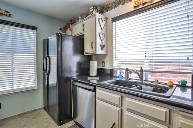 7331 Belpine Pl Unit 31, Rancho Cucamonga, CA 91730 - kitchen featuring dishwasher, dark countertops, light tile patterned floors, freestanding refrigerator, and white cabinetry