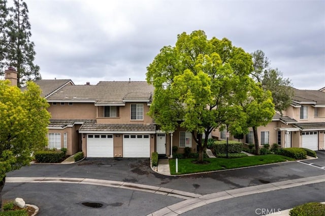 7331 Belpine Pl Unit 31, Rancho Cucamonga, CA 91730 - townhome / multi-family property featuring stucco siding, driveway, a garage, and a tiled roof
