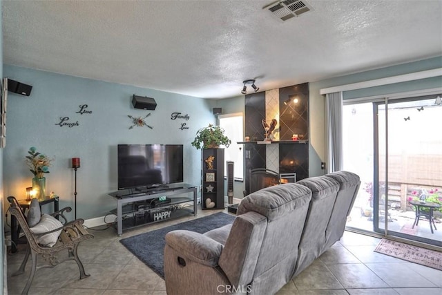 7331 Belpine Pl Unit 31, Rancho Cucamonga, CA 91730 - tiled living area with a textured ceiling and baseboards