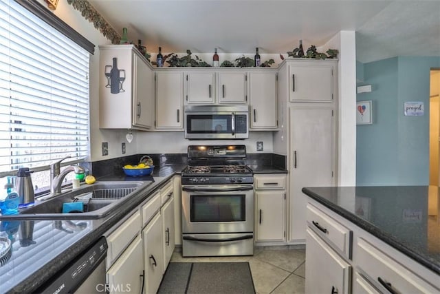 7331 Belpine Pl Unit 31, Rancho Cucamonga, CA 91730 - kitchen with stainless steel appliances, light tile patterned flooring, and white cabinets
