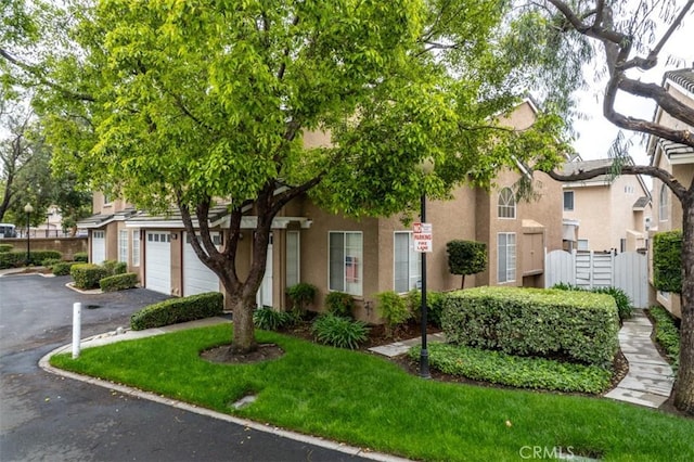 7331 Belpine Pl Unit 31, Rancho Cucamonga, CA 91730 - view of front of home with asphalt driveway, stucco siding, and an attached garage