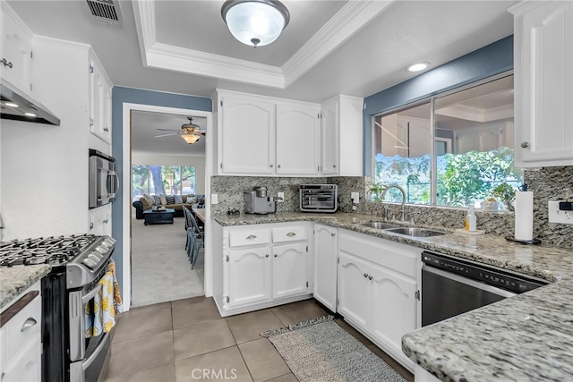 1239 Highridge St, Riverside, CA 92506 - kitchen with appliances with stainless steel finishes, a raised ceiling, light tile patterned floors, white cabinets, and ornamental molding