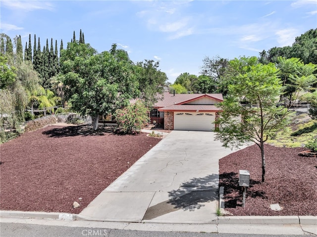 1239 Highridge St, Riverside, CA 92506 - view of front of house featuring driveway, a garage, and brick siding
