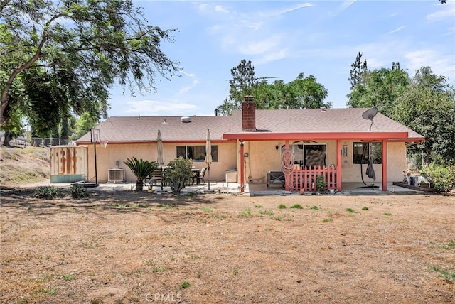 1239 Highridge St, Riverside, CA 92506 - back of property with stucco siding, a chimney, and a patio area