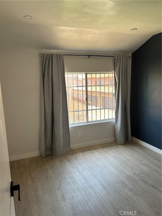 16600 Seville Ave Unit F, Fontana, CA 92335 - unfurnished room featuring wood finished floors and recessed lighting