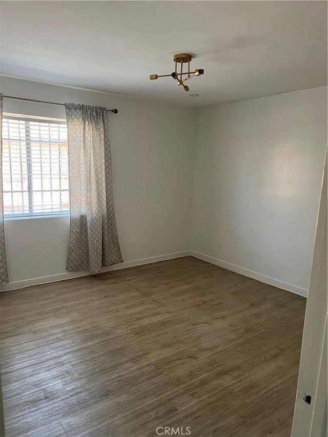 16600 Seville Ave Unit F, Fontana, CA 92335 - spare room with a chandelier and wood finished floors