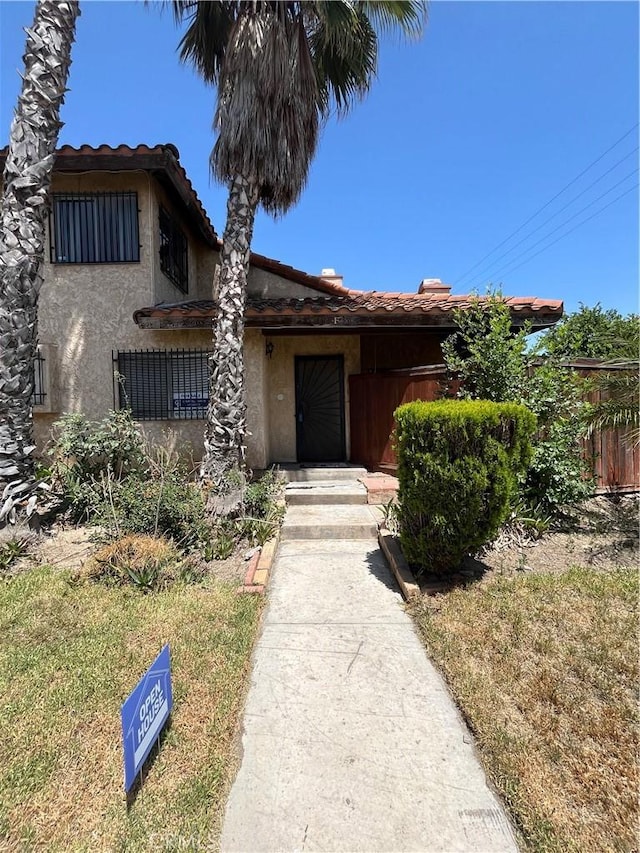 16600 Seville Ave Unit F, Fontana, CA 92335 - view of front facade with a tiled roof and stucco siding