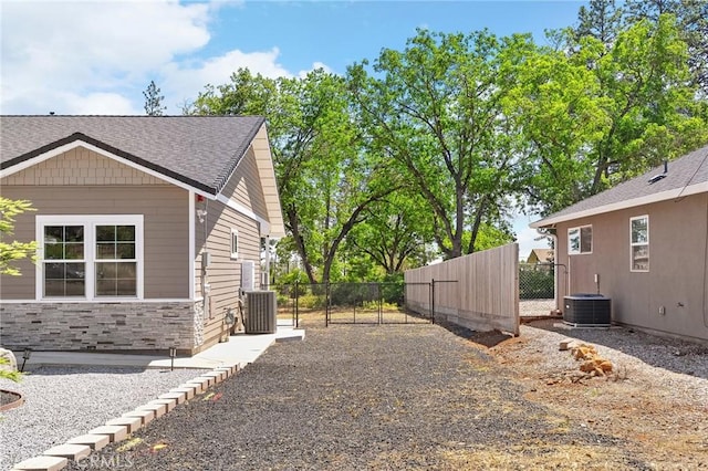 1906 Crandall Way, Paradise, CA 95969 - view of side of home featuring stone siding, a gate, and roof with shingles