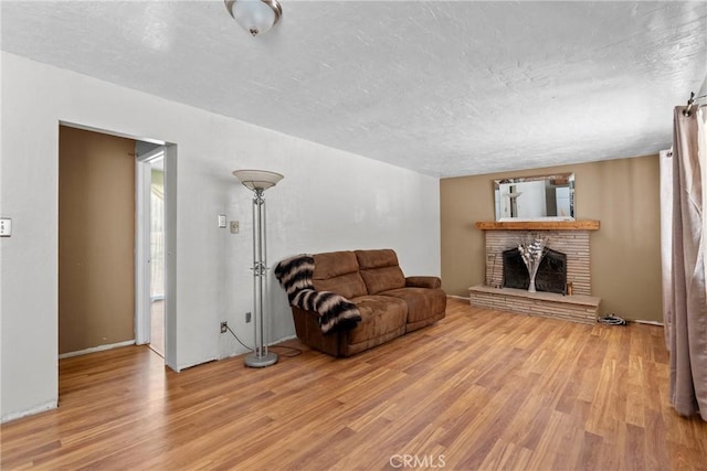 1529 Pomeroy Rd, Arroyo Grande, CA 93420 - living area with light wood-style flooring, a brick fireplace, and a textured ceiling