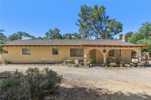 1529 Pomeroy Rd, Arroyo Grande, CA 93420 - back of house with a tiled roof, a chimney, stucco siding, and a porch