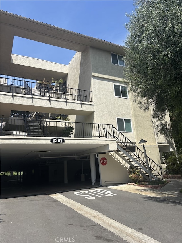 2391 Via Mariposa W Unit 2E, Laguna Woods, CA 92637 - view of building exterior featuring stairway