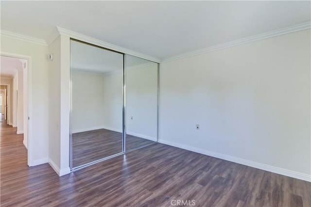 2391 Via Mariposa W Unit 2E, Laguna Woods, CA 92637 - unfurnished bedroom with dark wood-type flooring, ornamental molding, and a closet