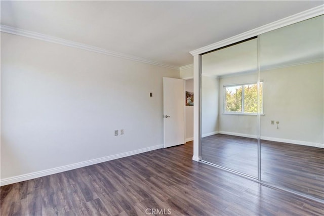 2391 Via Mariposa W Unit 2E, Laguna Woods, CA 92637 - unfurnished bedroom featuring dark wood-style flooring, ornamental molding, and a closet