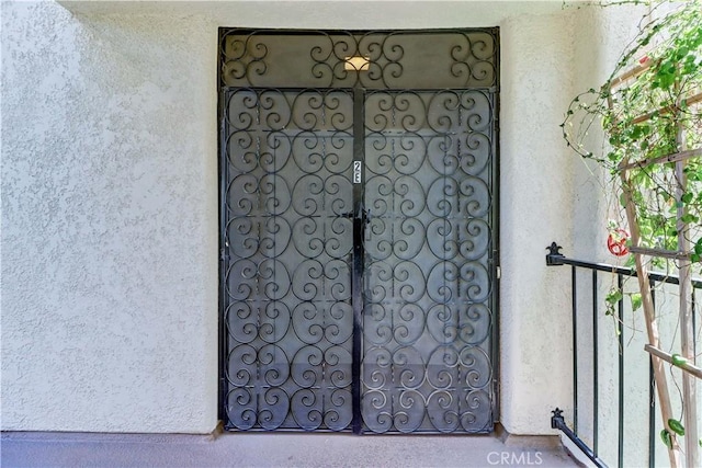 2391 Via Mariposa W Unit 2E, Laguna Woods, CA 92637 - doorway to property featuring stucco siding