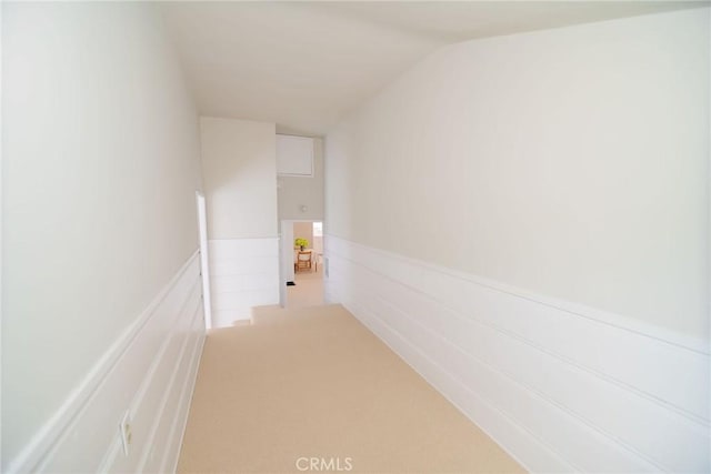 251 W 112th St, Los Angeles, CA 90061 - hall with vaulted ceiling, wainscoting, carpet flooring, and an upstairs landing