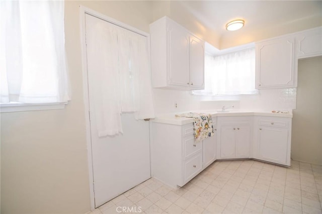 251 W 112th St, Los Angeles, CA 90061 - kitchen with white cabinetry and light countertops